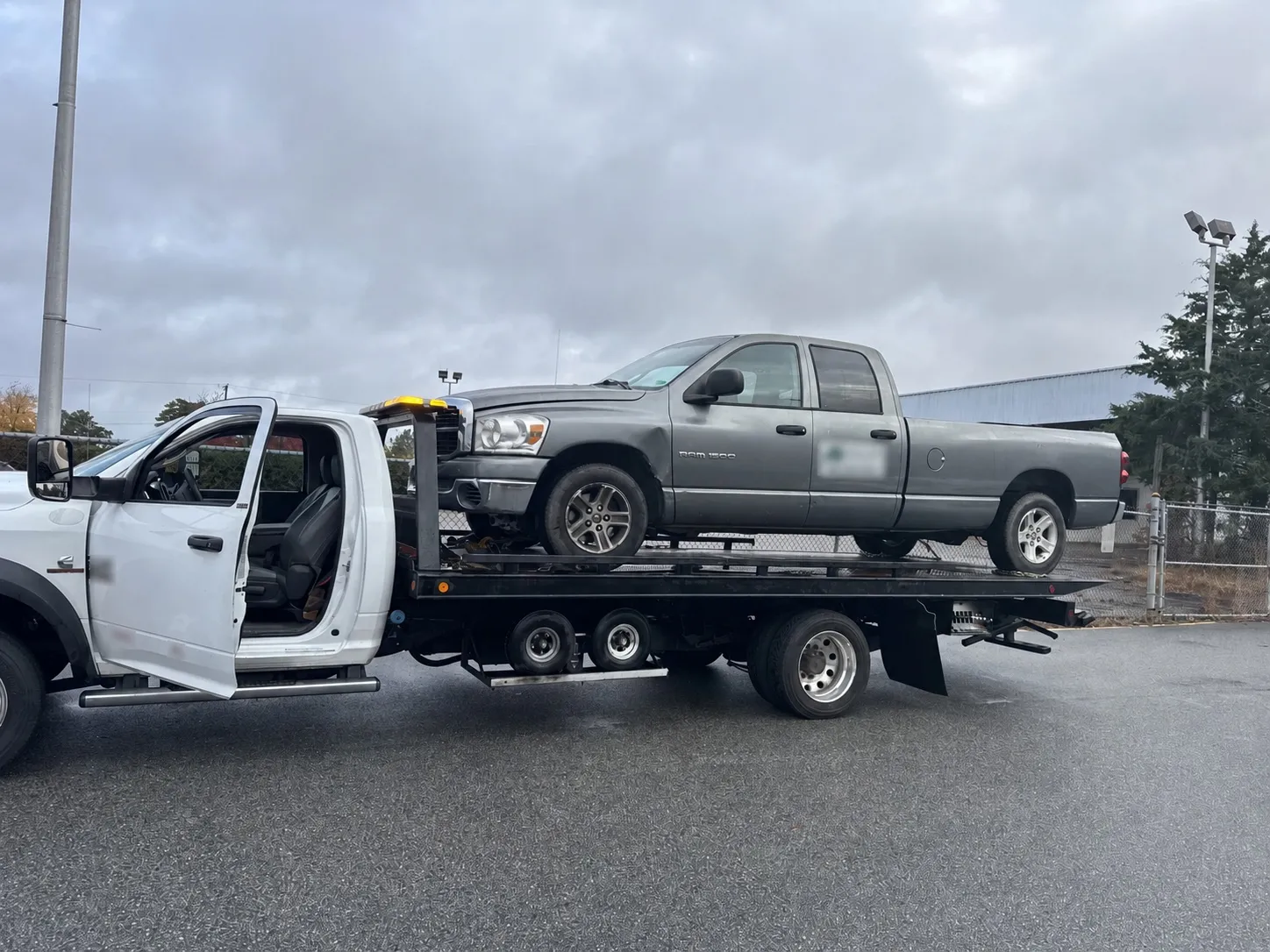 A vehicle on a flatbed being brought in for service